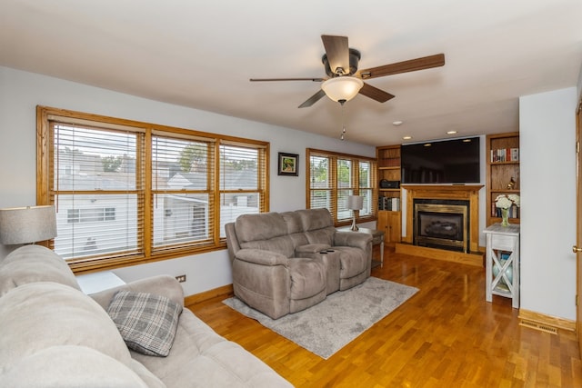 living room with ceiling fan and hardwood / wood-style flooring