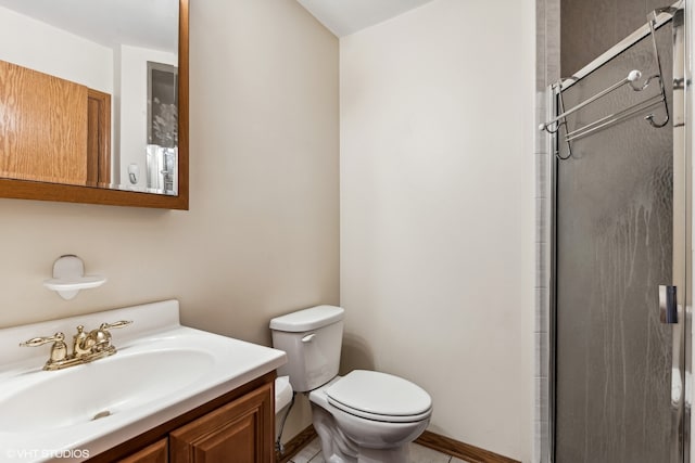 bathroom featuring toilet, tile patterned floors, vanity, and a shower with door