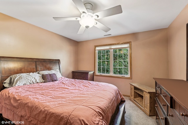 bedroom featuring light colored carpet and ceiling fan