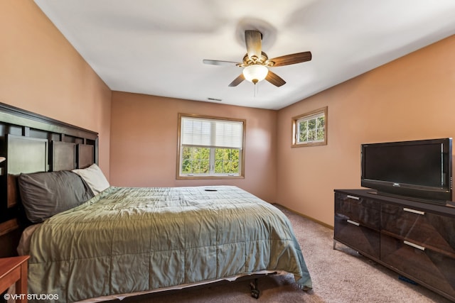 bedroom featuring light colored carpet and ceiling fan