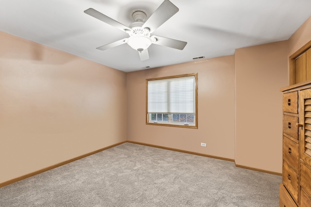 carpeted empty room with ceiling fan