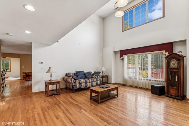 living room featuring a baseboard heating unit and light hardwood / wood-style floors