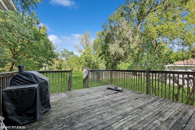 deck with grilling area and a lawn