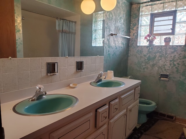 bathroom with walk in shower, vanity, toilet, and tasteful backsplash