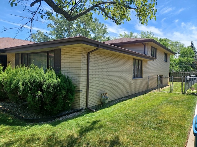 view of side of property with a lawn