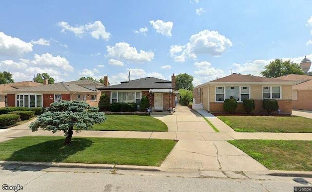 ranch-style home with a front lawn