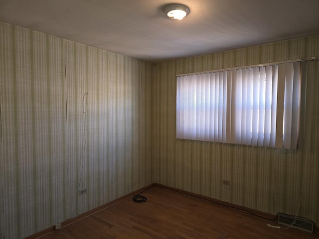 spare room with dark wood-type flooring