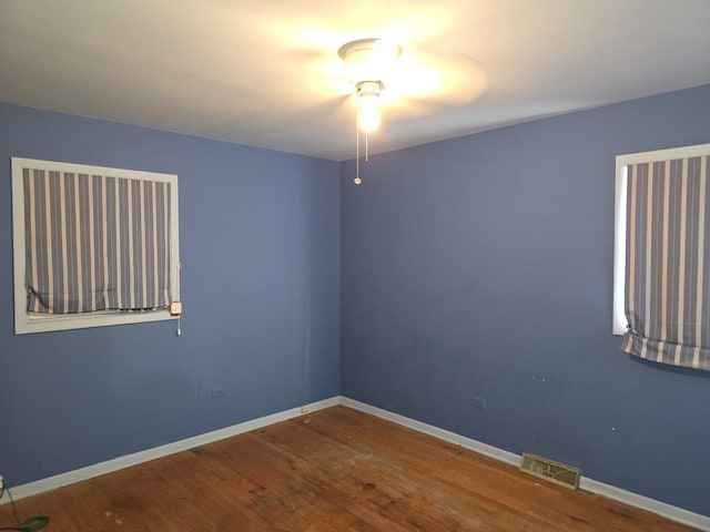 unfurnished room with hardwood / wood-style flooring