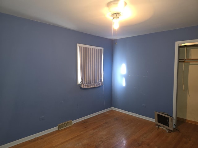 unfurnished bedroom featuring hardwood / wood-style floors and a closet