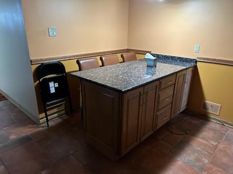 kitchen with kitchen peninsula and stone counters