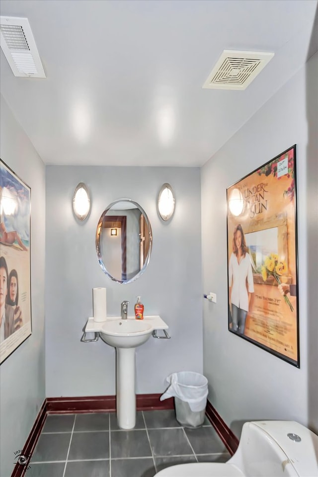 bathroom featuring toilet and tile patterned floors