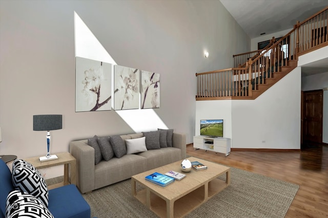 living room with a high ceiling and hardwood / wood-style floors