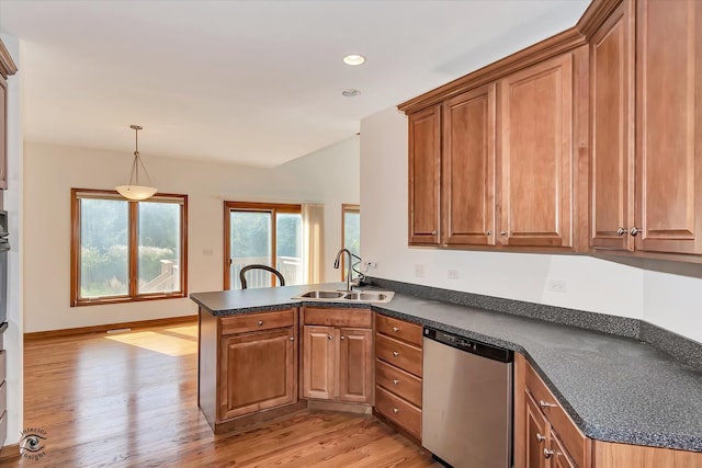 kitchen featuring kitchen peninsula, hanging light fixtures, stainless steel dishwasher, light wood-type flooring, and sink