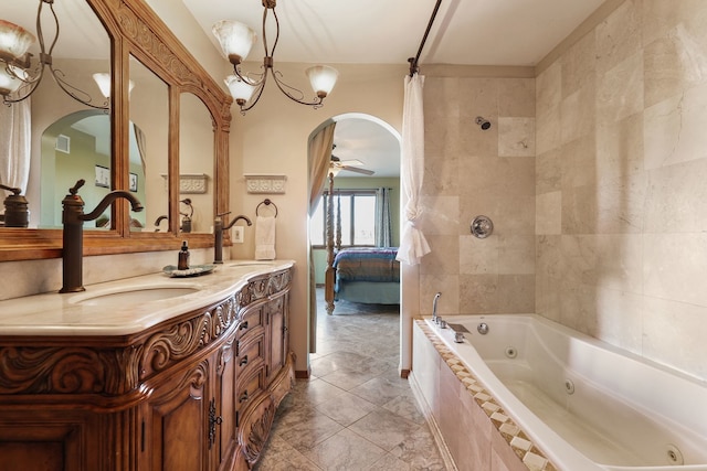 bathroom featuring ceiling fan with notable chandelier, vanity, and plus walk in shower