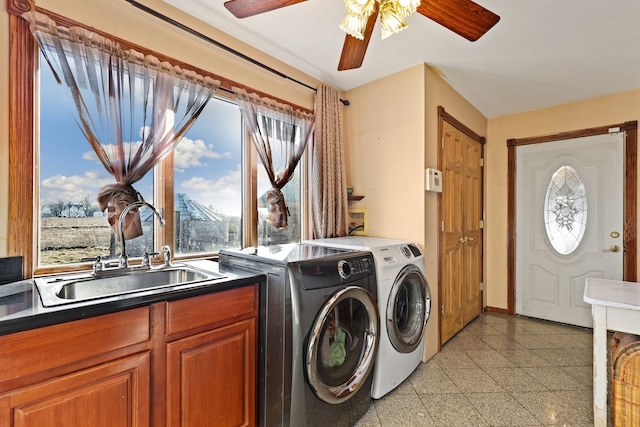 washroom featuring ceiling fan, washer and dryer, and sink