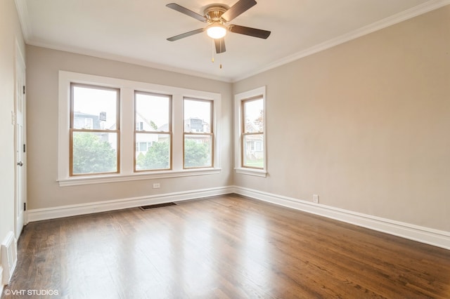 empty room featuring ceiling fan, ornamental molding, dark wood-type flooring, and a wealth of natural light