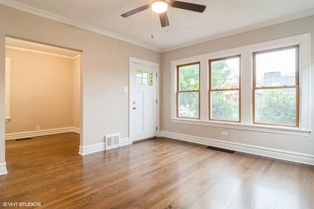 interior space with ceiling fan, dark hardwood / wood-style floors, and crown molding