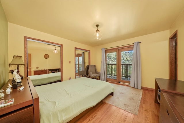 bedroom with access to outside and light wood-type flooring