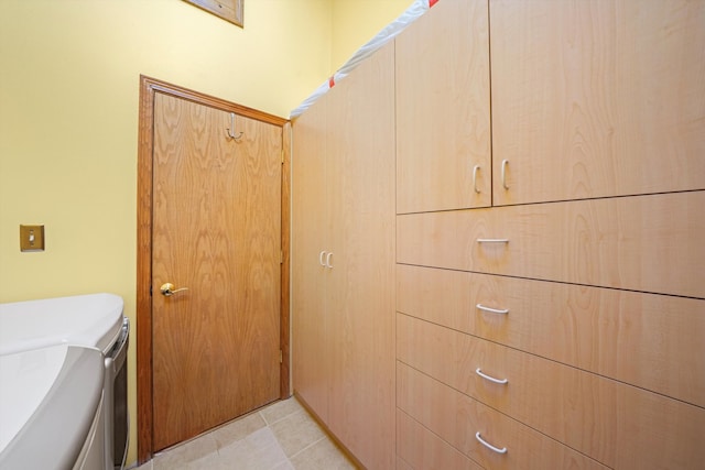 bathroom featuring washer and clothes dryer, vanity, and toilet