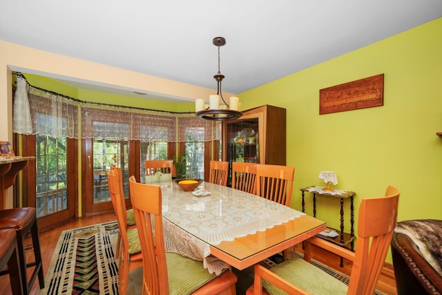 dining space featuring a notable chandelier and hardwood / wood-style flooring