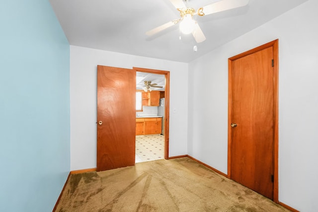 unfurnished room with ceiling fan and carpet flooring