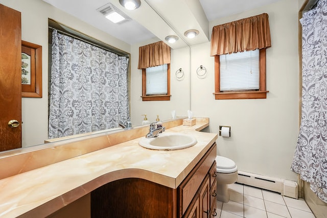 bathroom featuring tile patterned flooring, plenty of natural light, baseboard heating, vanity, and toilet