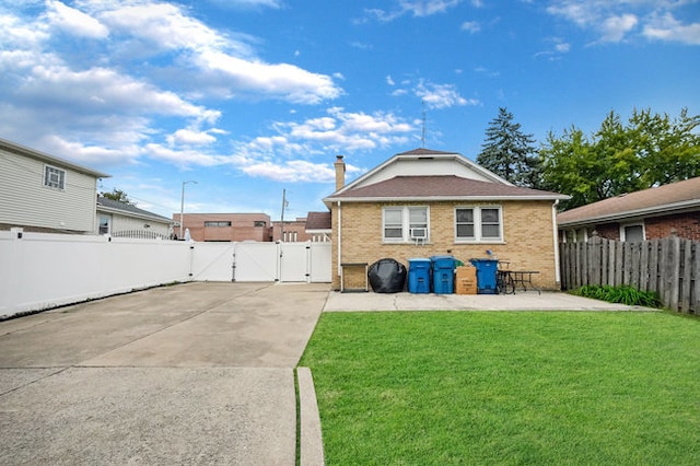 back of house featuring a yard and a patio area