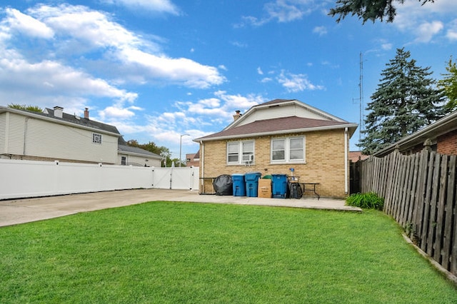 back of property featuring a yard and a patio area