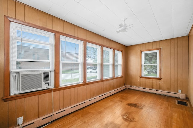 unfurnished sunroom with a baseboard radiator, cooling unit, and ceiling fan