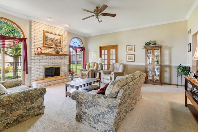 living room featuring ceiling fan, light colored carpet, a fireplace, and crown molding