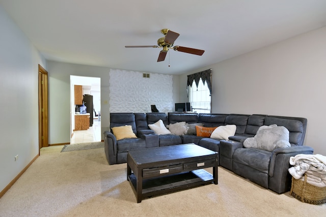 carpeted living room with ceiling fan