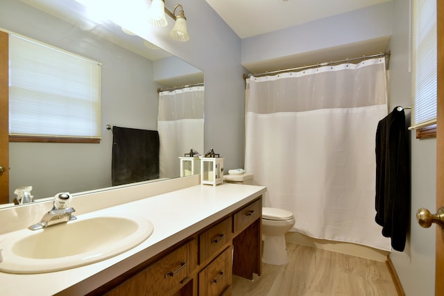 bathroom with curtained shower, vanity, toilet, and hardwood / wood-style flooring