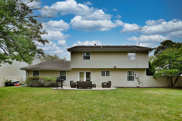 rear view of property with a yard and a patio