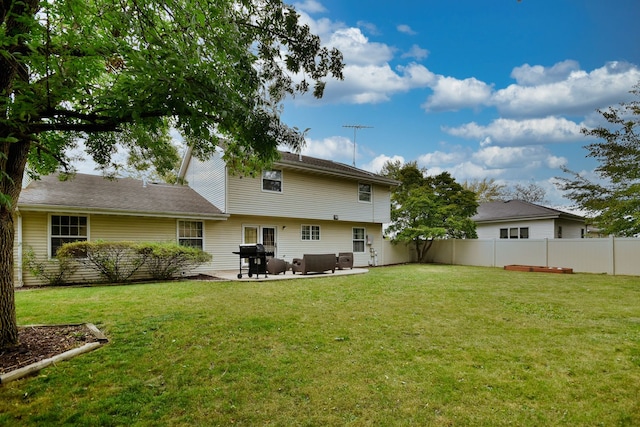 back of house featuring a yard and a patio