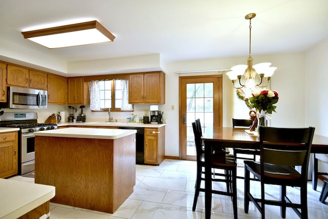 kitchen featuring stainless steel appliances, a center island, hanging light fixtures, and a healthy amount of sunlight