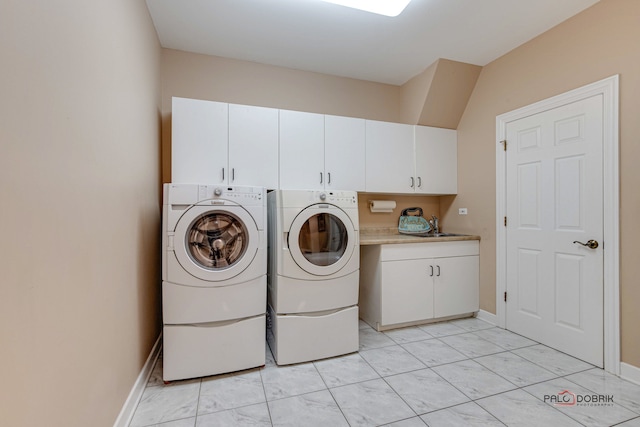 laundry room featuring cabinets and independent washer and dryer