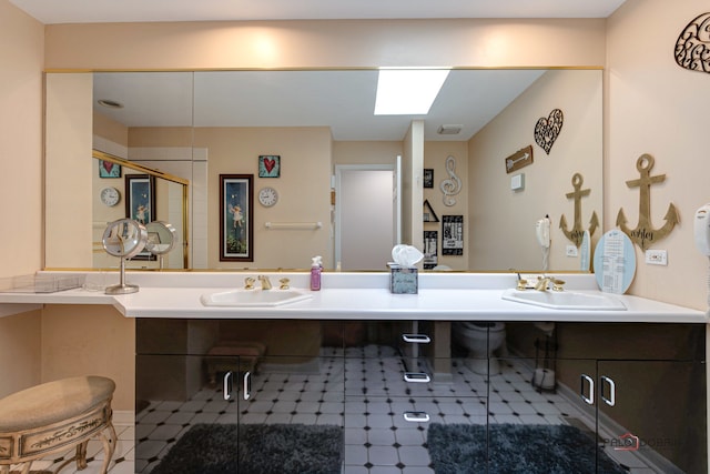 bathroom with a skylight, walk in shower, and vanity