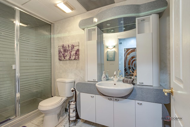 bathroom with vanity, toilet, tile patterned floors, and a shower with shower door