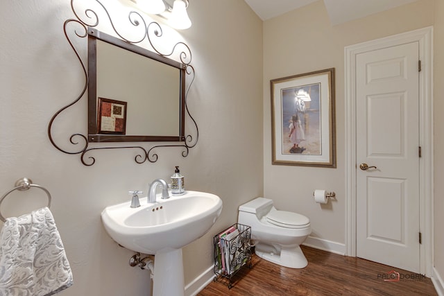 bathroom featuring hardwood / wood-style floors and toilet