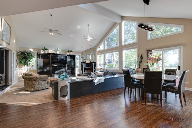 dining space featuring high vaulted ceiling, ceiling fan, beamed ceiling, and dark hardwood / wood-style flooring