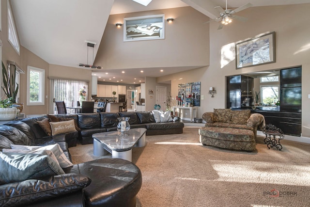 living room featuring high vaulted ceiling, ceiling fan, and carpet flooring