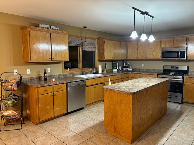 kitchen featuring hanging light fixtures, light tile patterned flooring, stainless steel appliances, sink, and a center island