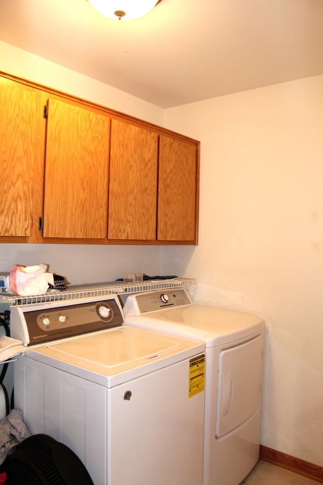 washroom with cabinets and independent washer and dryer