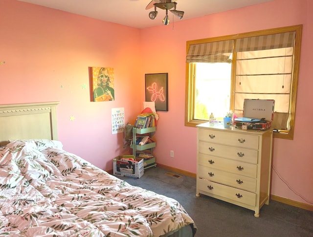 bedroom featuring dark colored carpet