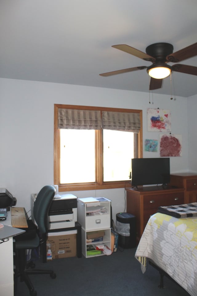 carpeted bedroom with multiple windows and ceiling fan