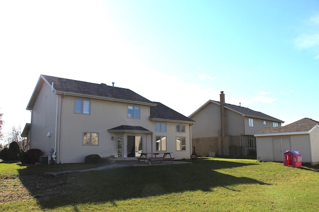 back of property featuring a patio, central AC, and a lawn