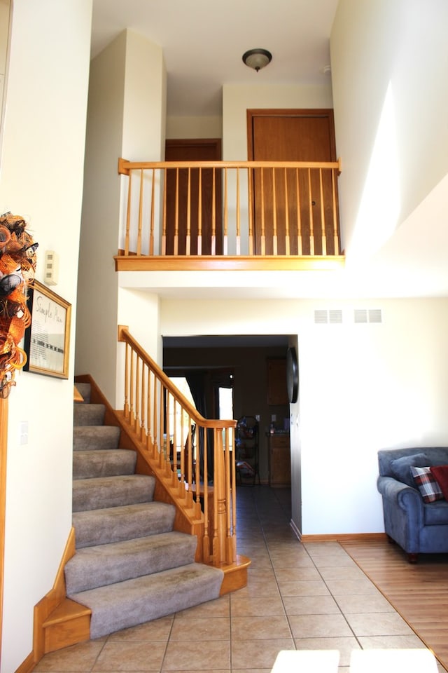 staircase featuring tile patterned floors