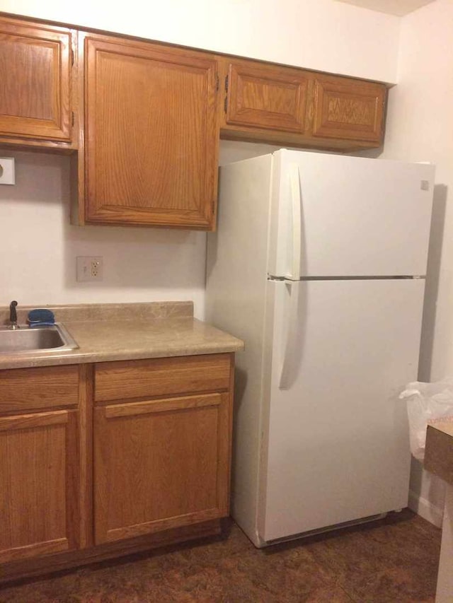 kitchen featuring white refrigerator and sink