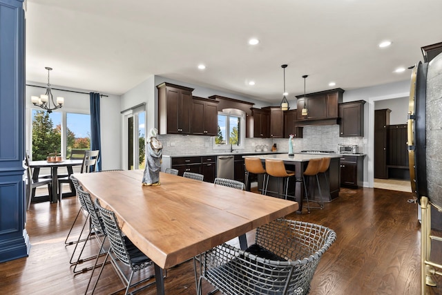 dining room with dark hardwood / wood-style floors, a chandelier, and plenty of natural light