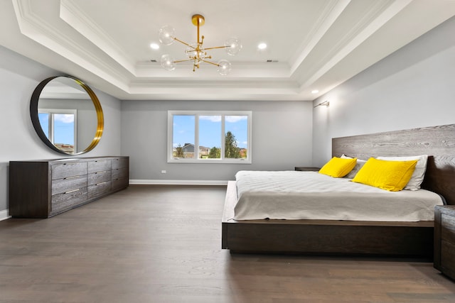 bedroom with ornamental molding, a tray ceiling, and dark wood-type flooring